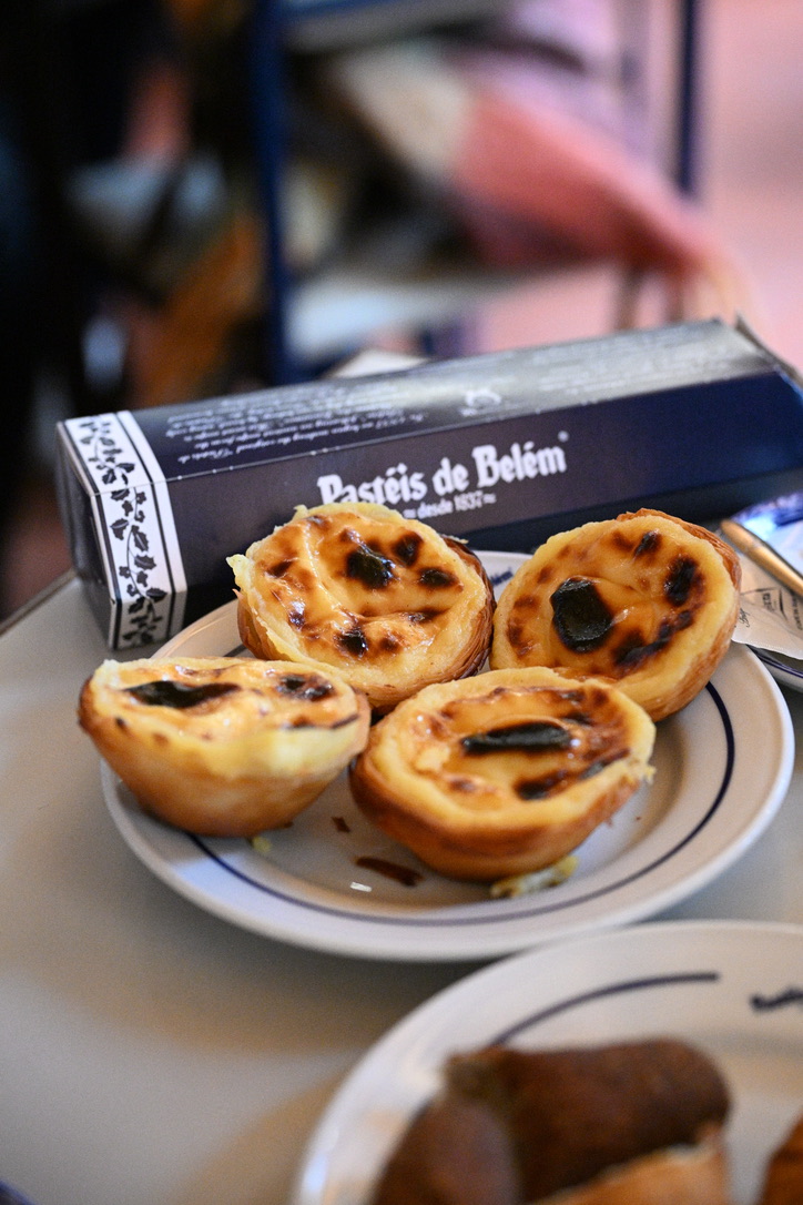 Portuguese custard tarts on a blue-rimmed plate