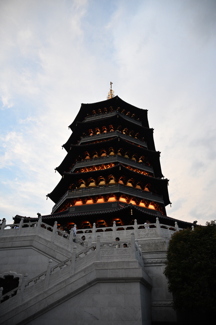 Tall multi-tiered pagoda with lit eaves against the sky